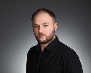 Professional headshot of YSM staff or affiliate against a grey background.