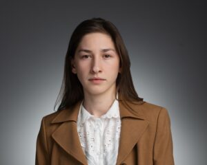Professional headshot of YSM staff or affiliate against a grey background.